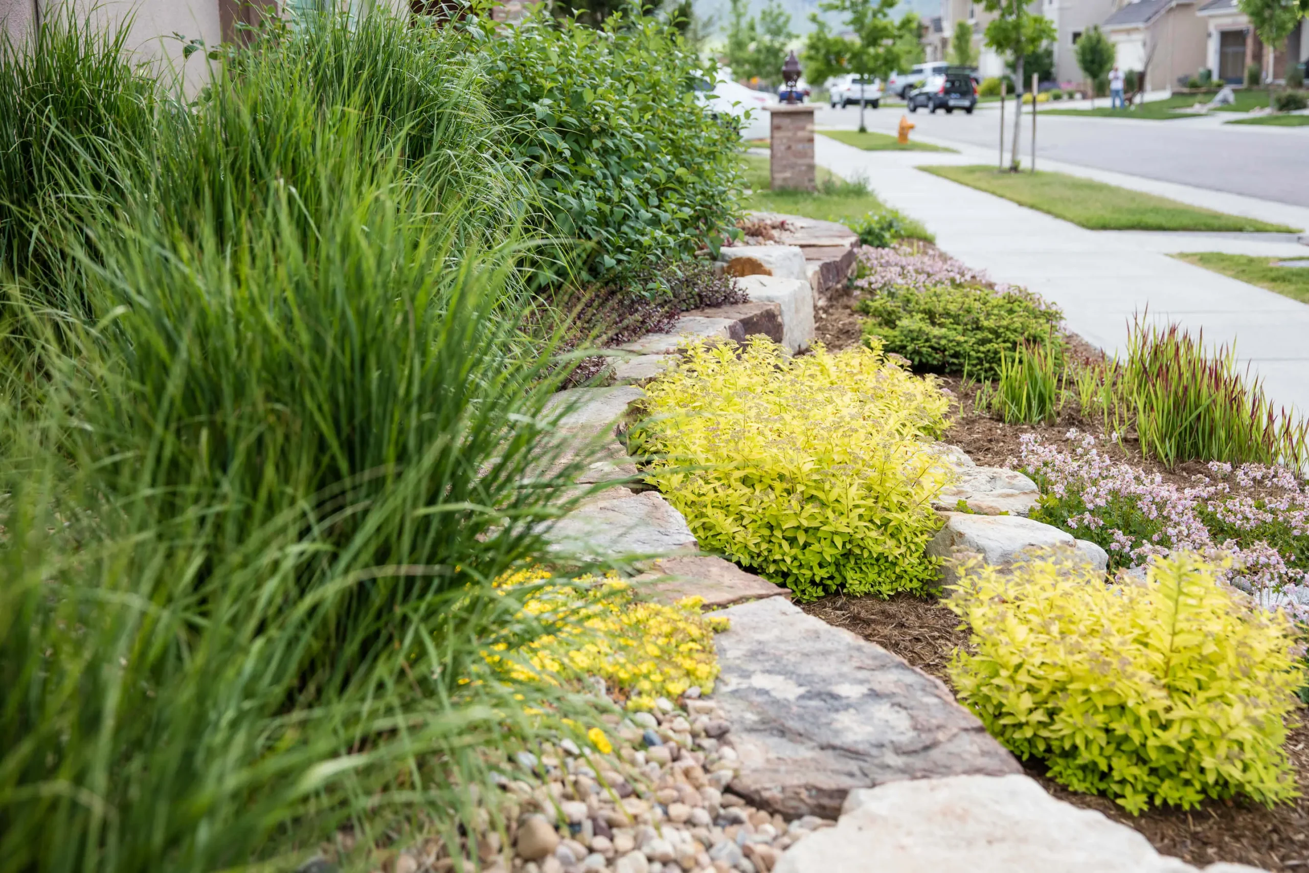Custom flagstone patio pathway with natural stone retaining walls and built-in hardscape features in a Denver yard.
