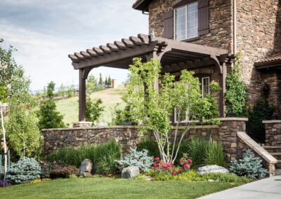 stone house with pergola and patio