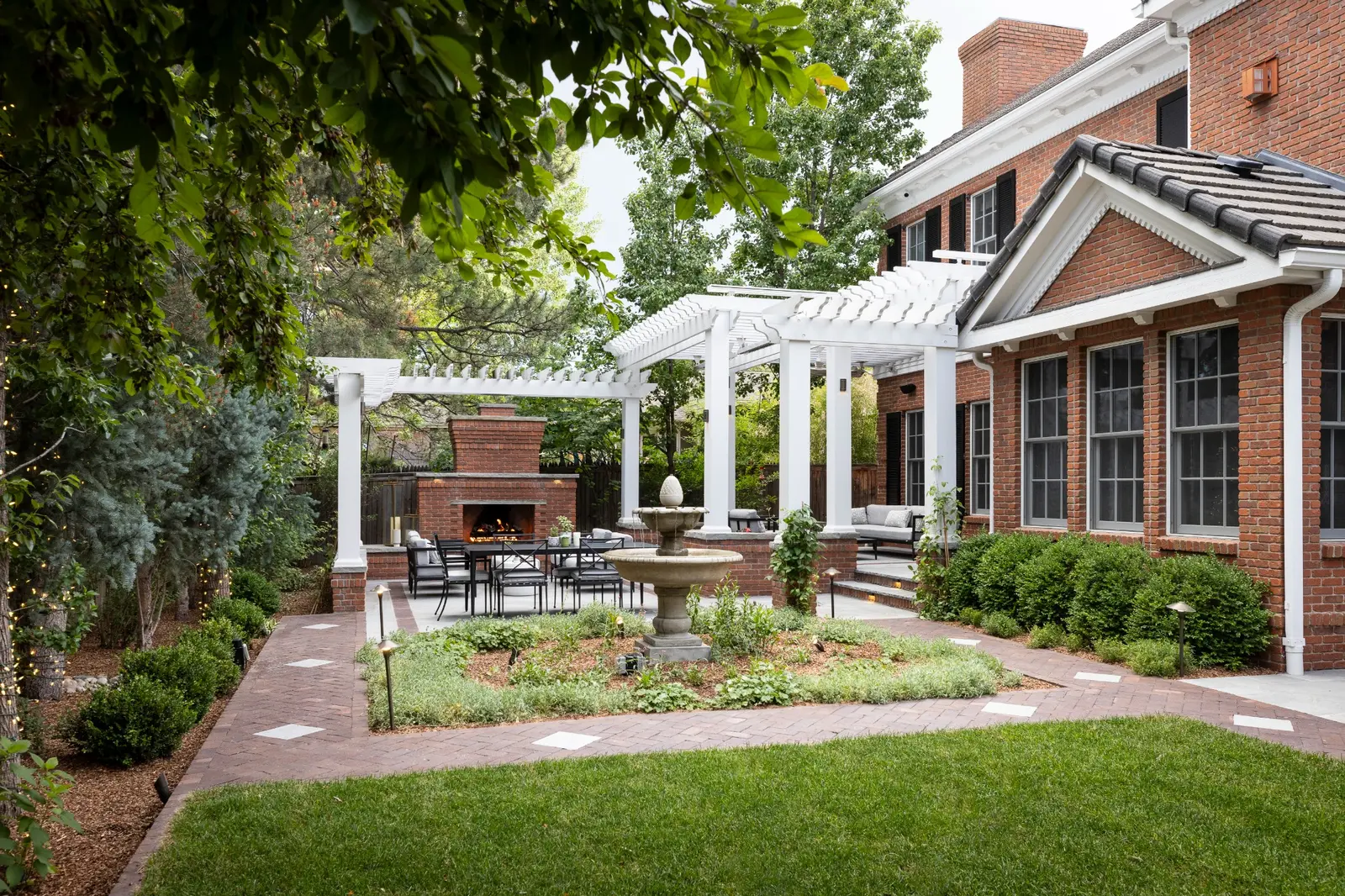 denver-spring-landscape-preparation-backyard-design Well-maintained Denver backyard with patio, pergola, and fresh landscaping after spring yard preparation