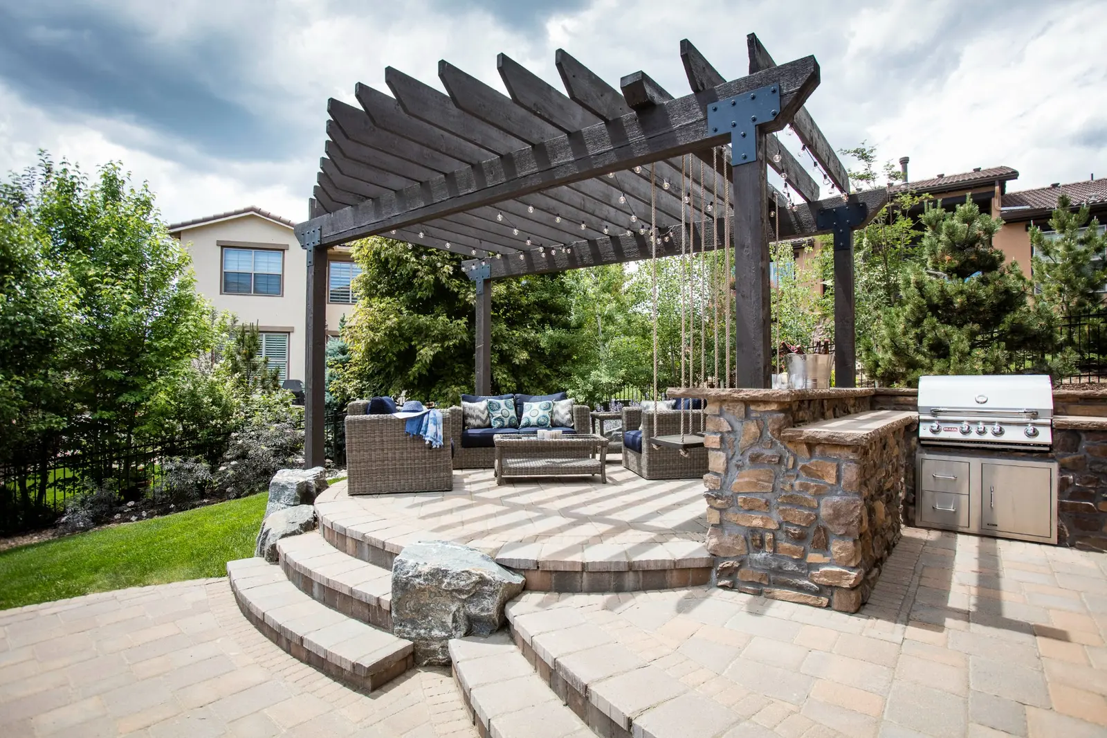 outdoor-kitchen-design-denver-backyard Outdoor kitchen design in a Denver backyard with pergola, built-in grill, and patio seating area