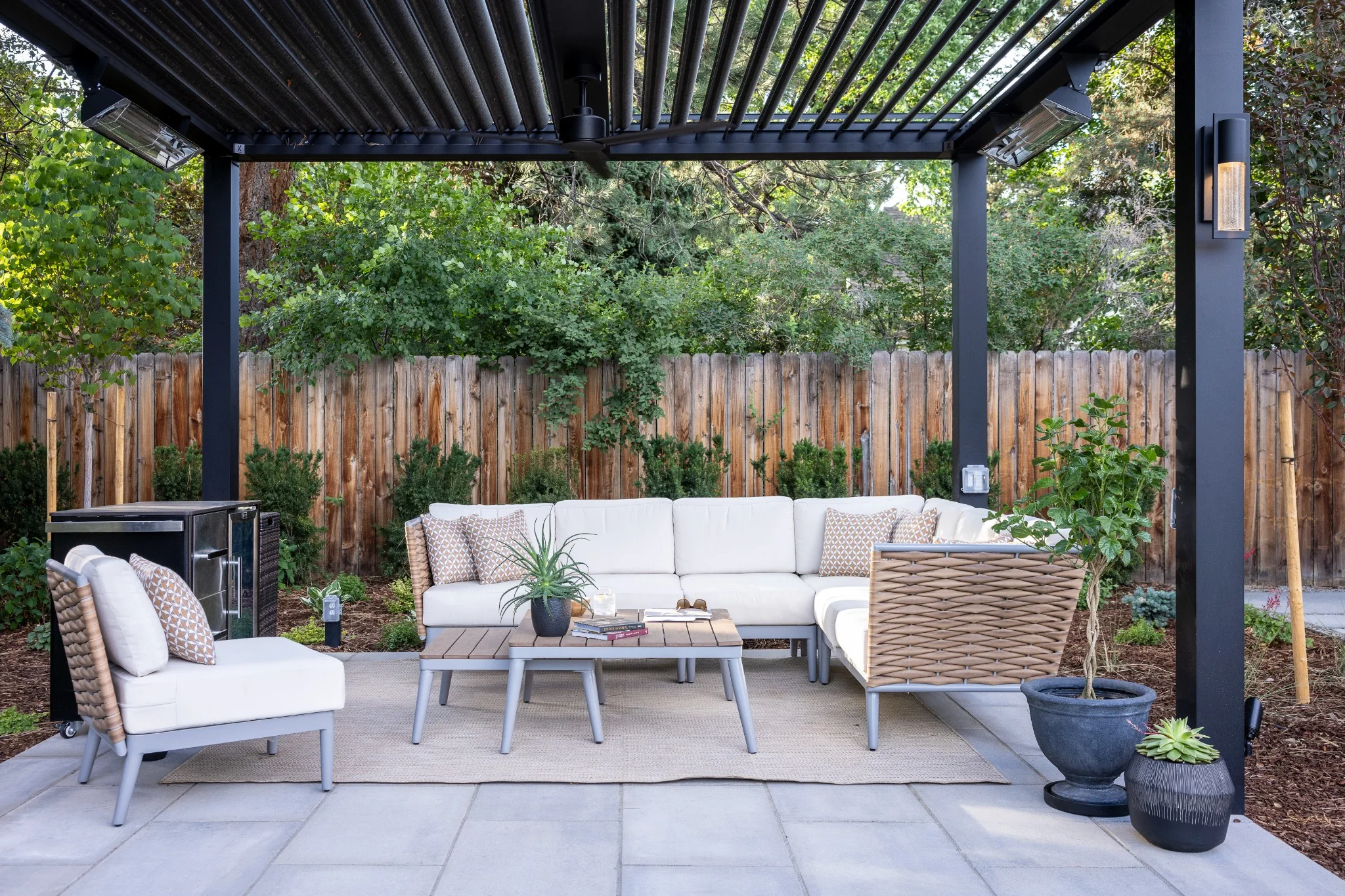 adjustable-louvered-pergola-colorado-patio Adjustable louvered pergola over a Colorado patio with outdoor seating, heaters, and integrated lighting