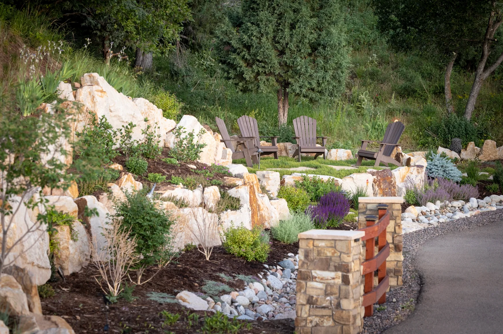 colorado-xeriscape-rock-garden Colorado xeriscape rock garden with drought-tolerant plants, natural stone, and a hillside seating area